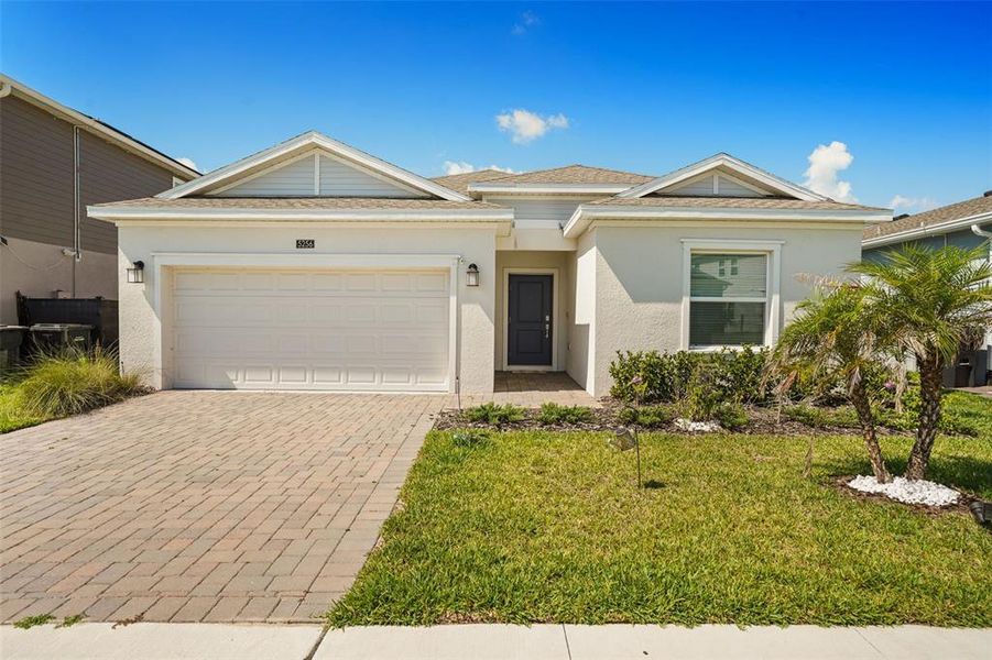 Front exterior of a new home in Providence, Davenport, FL, highlighting curb appeal (Image 1). Front exterior of a new home in Providence, Davenport, FL, highlighting curb appeal (Image 1).