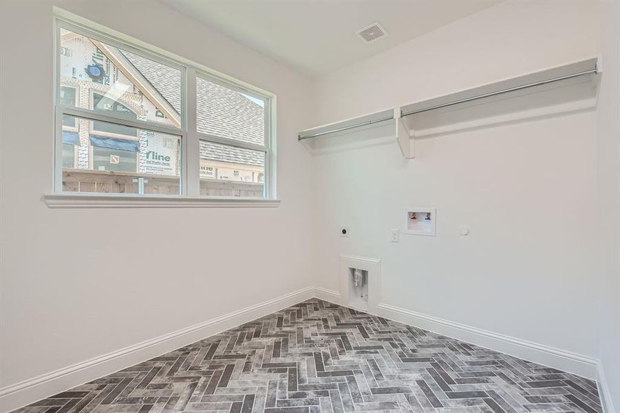 Laundry room with gas dryer hookup, hookup for an electric dryer, and washer hookup