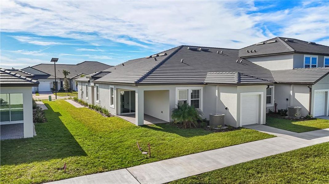 Front exterior of a new home in Mirada Active Adult: Active Adult Lagoon Villas, San Antonio, FL, highlighting curb appeal (Image 25). Front exterior of a new home in Mirada Active Adult: Active Adult Lagoon Villas, San Antonio, FL, highlighting curb appeal (Image 25).