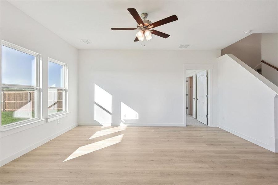 Spare room featuring ceiling fan and light wood-type flooring