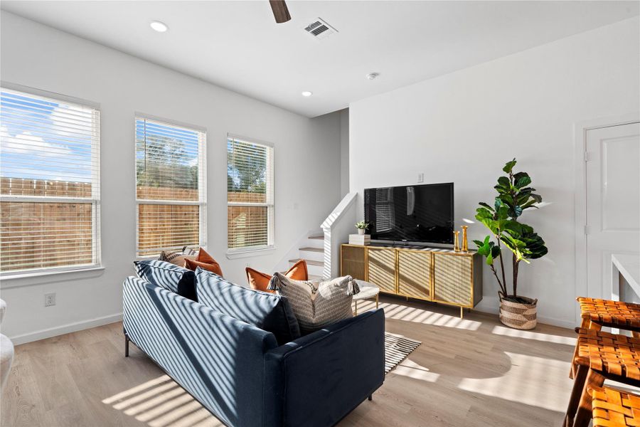 Sun-filled living room with large windows that make the space feel open and bright all day. Sun-filled living room with large windows that make the space feel open and bright all day.
