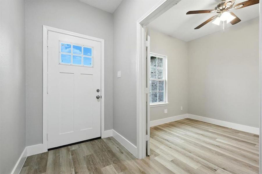 Foyer entrance featuring light wood-style floors and ceiling fan Foyer entrance featuring light wood-style floors and ceiling fan