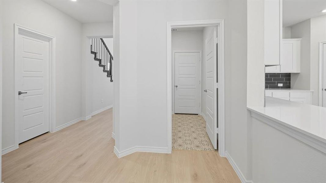 Hall with recessed lighting, light wood-type flooring, and stairway Hall with recessed lighting, light wood-type flooring, and stairway