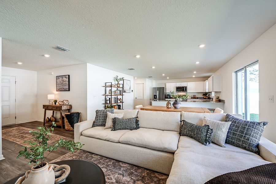 A living room with a couch and a table. A living room with a couch and a table.