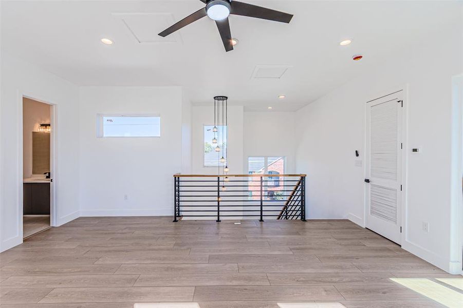 Spare room featuring recessed lighting, light wood-type flooring, ceiling fan, and attic access