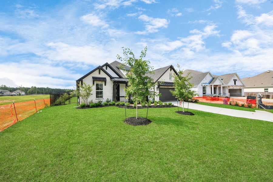 Front exterior of a new home in ARTAVIA: Hilltop Collection, Conroe, TX, highlighting curb appeal (Image 16). Front exterior of a new home in ARTAVIA: Hilltop Collection, Conroe, TX, highlighting curb appeal (Image 16).