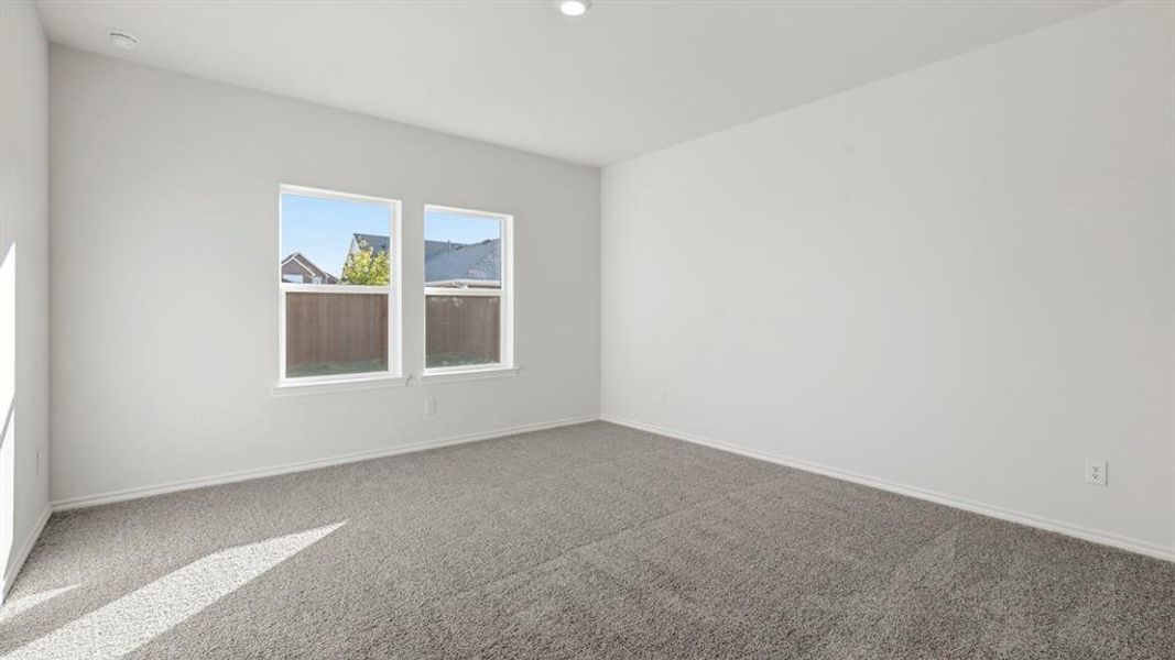 Carpeted empty room with baseboards