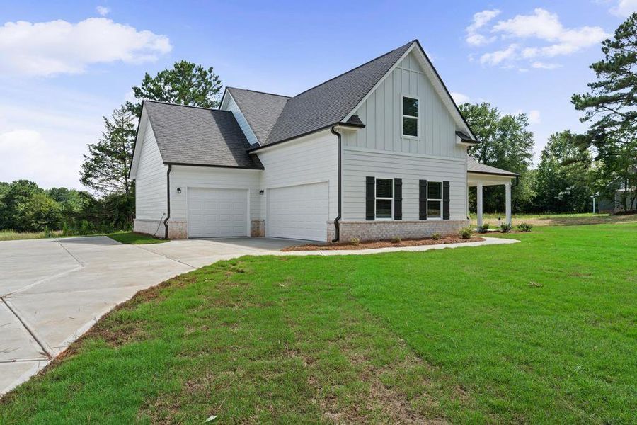 Front exterior of a new home in , McDonough, GA, highlighting curb appeal (Image 1). Front exterior of a new home in , McDonough, GA, highlighting curb appeal (Image 1).