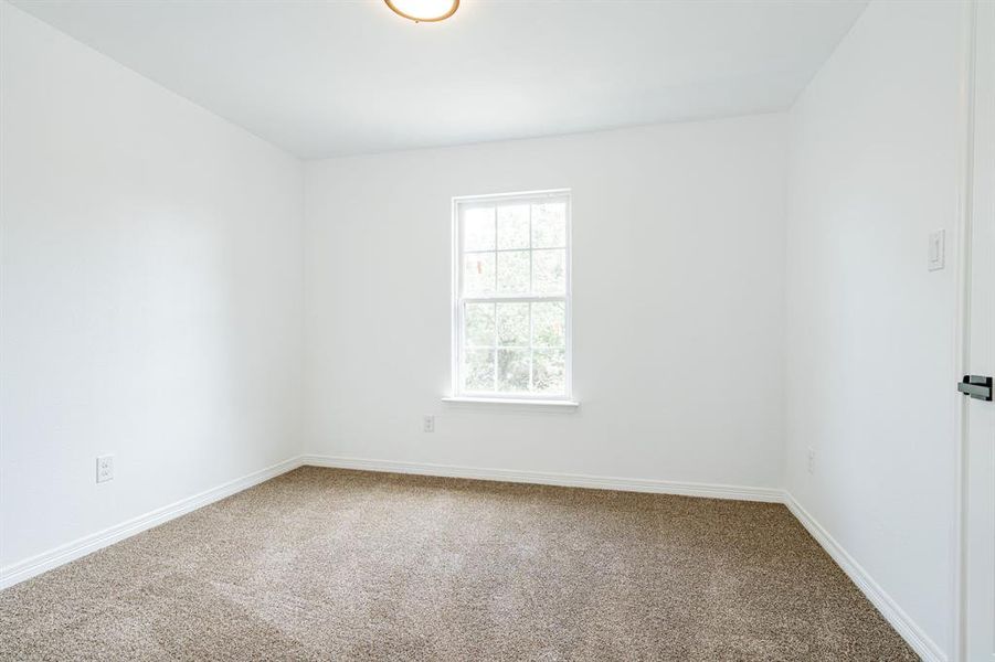 Spare room featuring carpet flooring