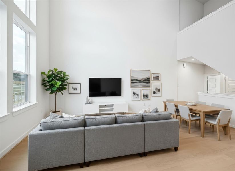 Comfortable living area offers a welcoming layout with direct access to the balcony for easy indoor-outdoor living. Neutral tones and layered textures bring warmth to the open concept space, creating an inviting area for conversation or quiet evenings at home. *Virtually Staged*