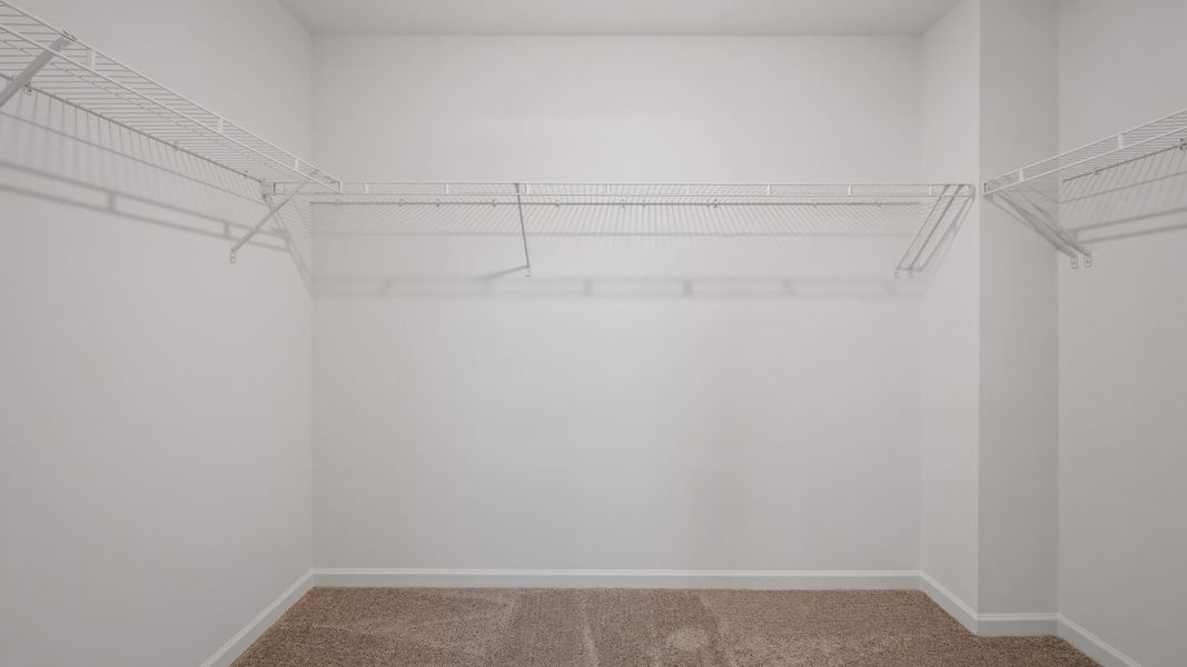 Walk-in closet with built-in shelving and ample storage in Langley Overlook townhome in Loganville, GA. Walk-in closet with built-in shelving and ample storage in Langley Overlook townhome in Loganville, GA.
