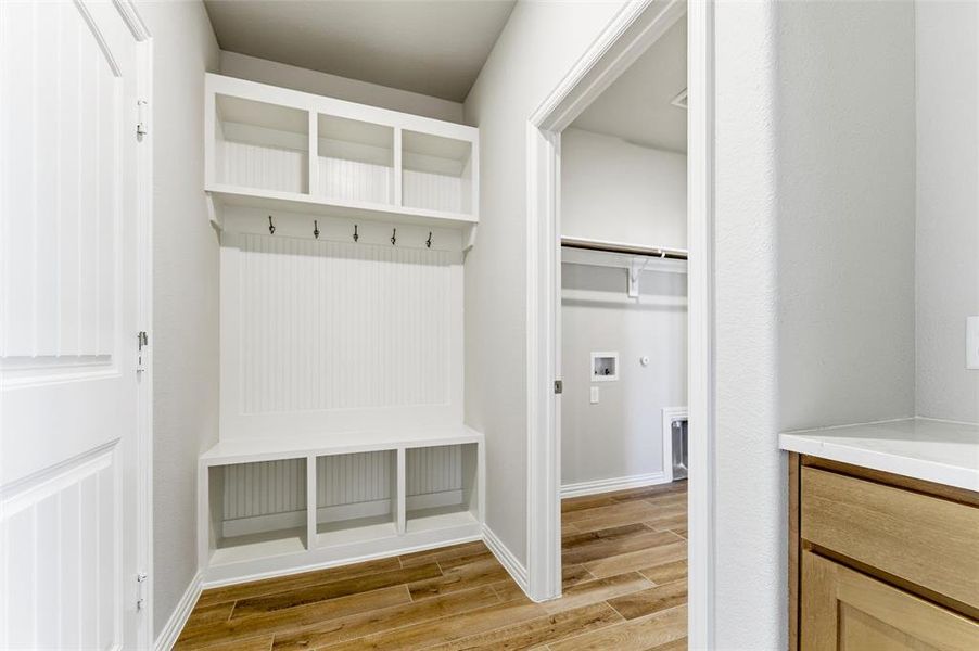 Mudroom with wood finish floors and baseboards