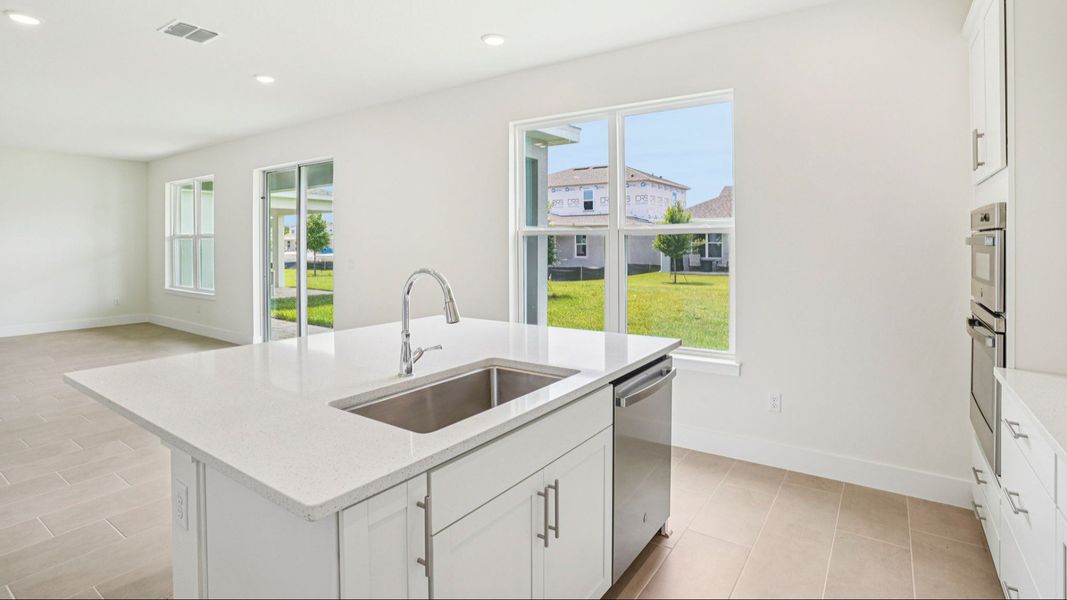 Plumeria Floor Plan featuring a bright kitchen with large island by DRB Homes in Trailside located in Mount Dora, FL Plumeria Floor Plan featuring a bright kitchen with large island by DRB Homes in Trailside located in Mount Dora, FL