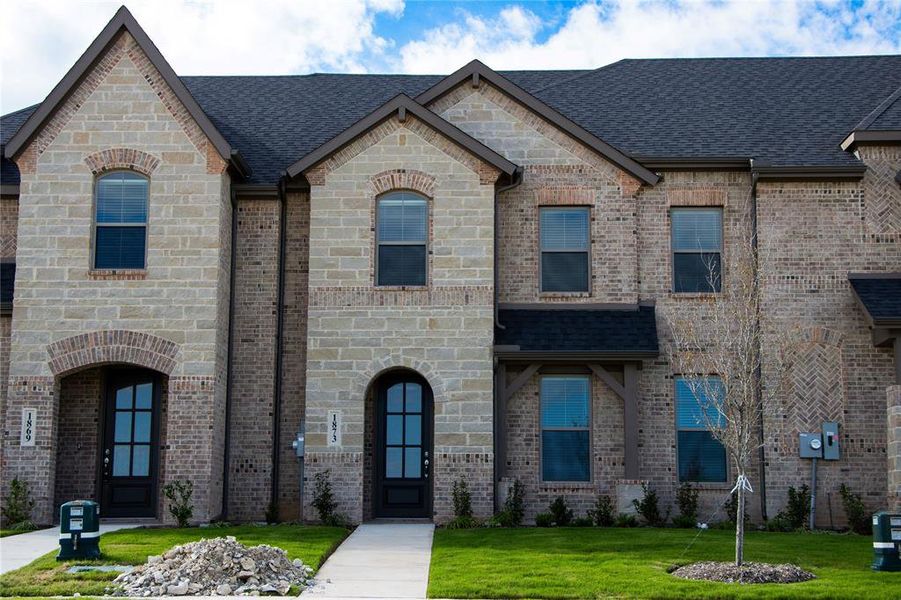 French country home featuring a front yard