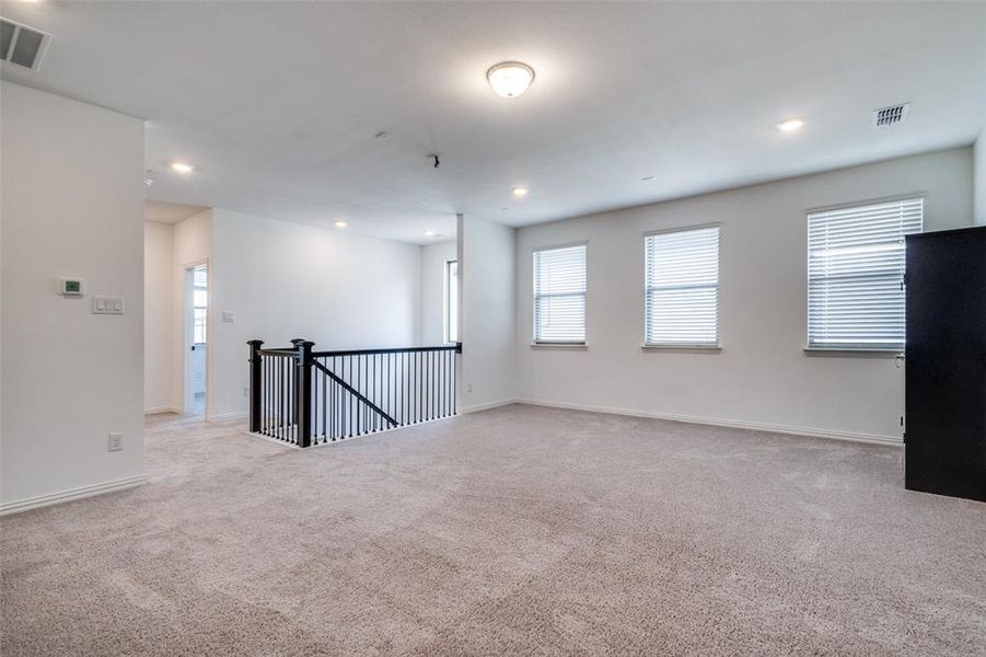 Empty room featuring light carpet