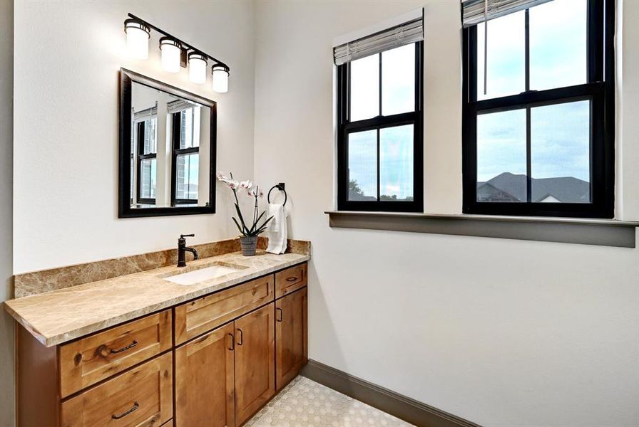 Bathroom featuring vanity and healthy amount of natural light