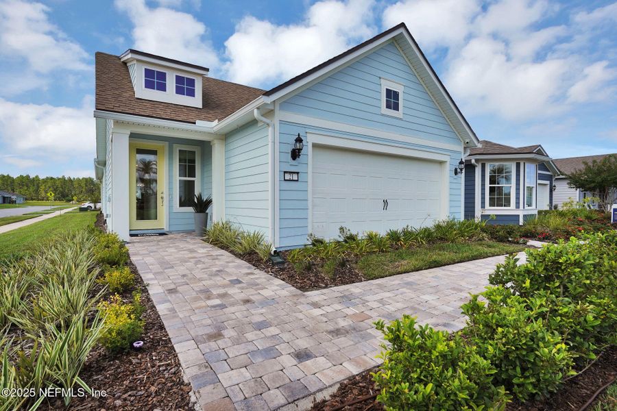 Front exterior of a new home in Summer Bay at Grand Oaks, St. Augustine, FL, highlighting curb appeal (Image 25).