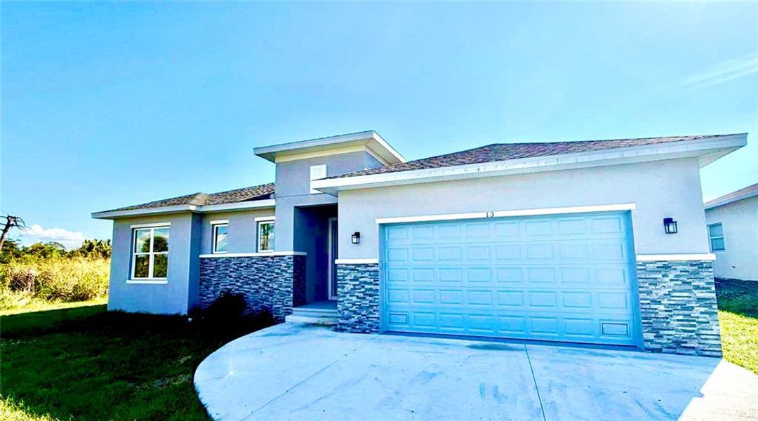 Front exterior of a new home in , Placida, FL, highlighting curb appeal (Image 1).