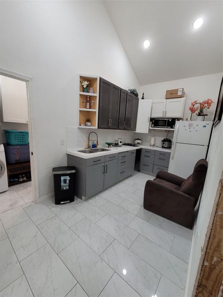 A compact culinary space is efficiently arranged with recessed lighting and essential appliances. A compact culinary space is efficiently arranged with recessed lighting and essential appliances.