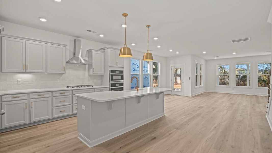 Memorable meals begin in this vibrant kitchen with pendant lighting and a thoughtfully designed island