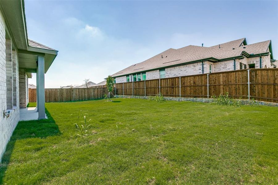 Exterior details and patio area of a home in The Preserve Estates, Justin (Image 19).