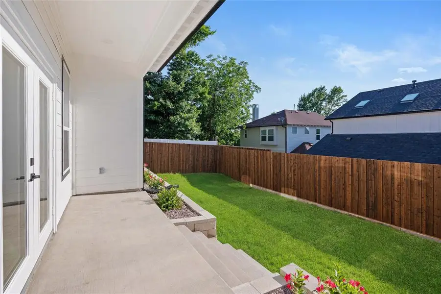 Fenced backyard with a patio