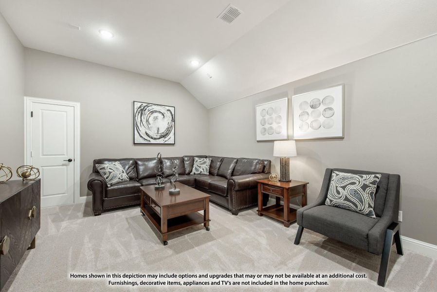 Living room with vaulted ceiling, dark leather sectional sofa, accent chair, and carpet flooring