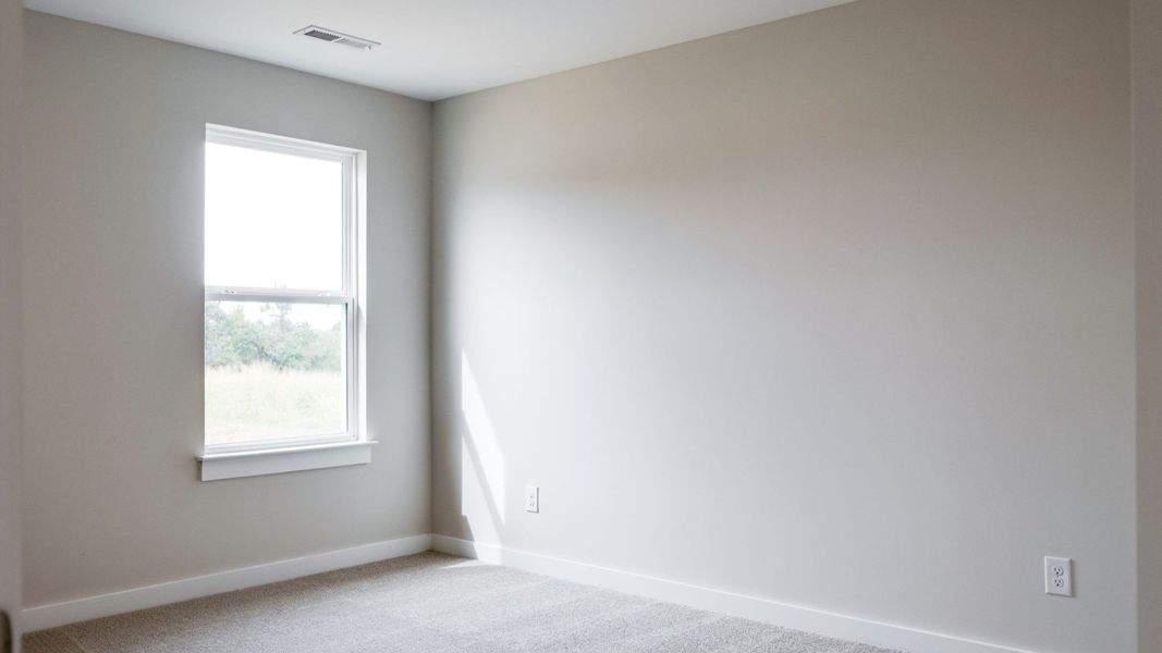 Secondary bedroom with window and double door closet