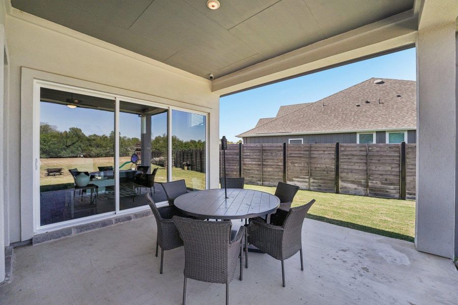 The covered back patio is perfect for entertaining or simply unwinding while enjoying the peaceful river backdrop.