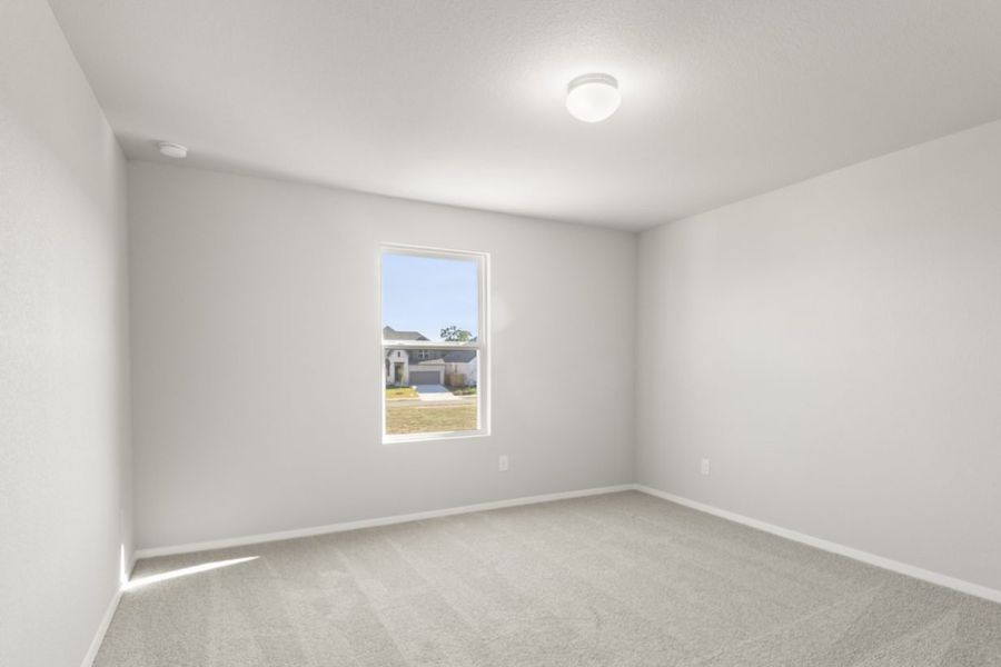 Image of a bedroom with tan carpeting and light grey painted walls with a window Image of a bedroom with tan carpeting and light grey painted walls with a window