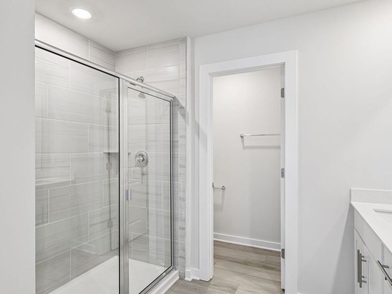 The primary bathroom offers dual vanity sinks and a walk-in shower.