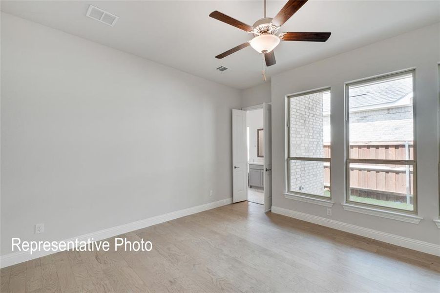 Unfurnished room with light hardwood / wood-style flooring and ceiling fan