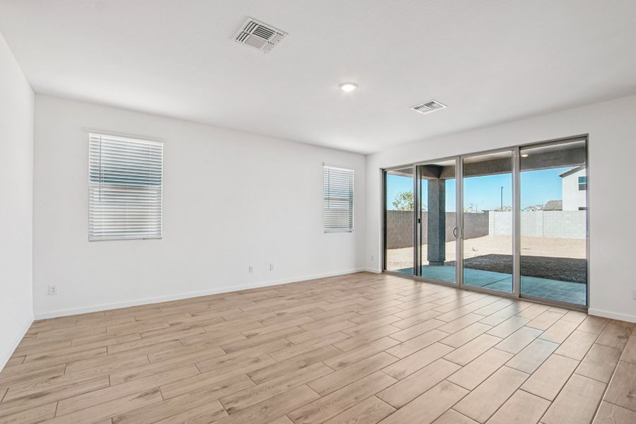 Great room with upgraded 4 panel slider. Finishes and options may vary by community.