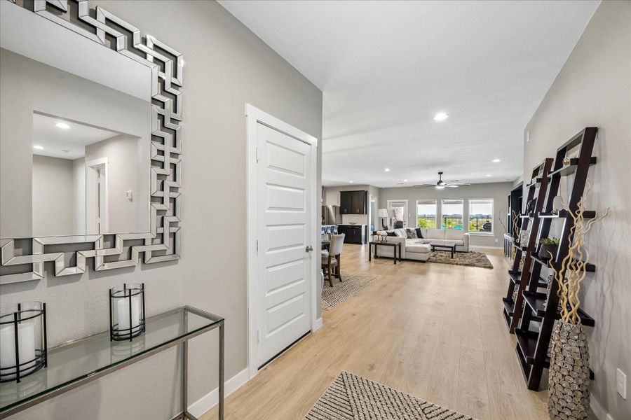 Upon entering the home is this foyer with an incredible view of the living room straight ahead, and kitchen to the left.  Straight through those windows is the pond ... waterfall ... walking trail.