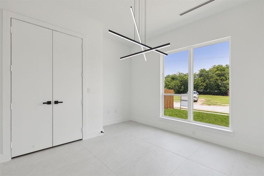 Unfurnished bedroom featuring a closet and light tile patterned floors