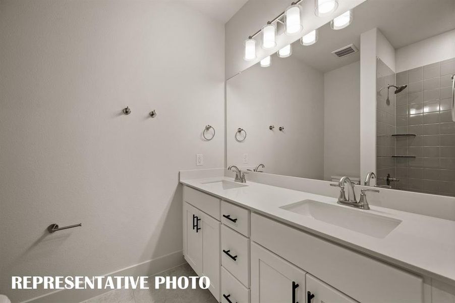 Guests will enjoy their own vanity space in this thoughtfully designed guest bath.