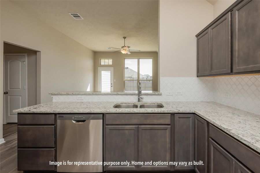 Kitchen with dark brown cabinets, light stone counters, dishwasher, a peninsula, and tasteful backsplash