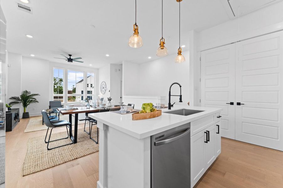 This stylish kitchen features sleek quartz countertops that offer both durability and elegance, paired with a spacious center island perfect for meal prep and casual dining. Surrounding the space is a generous array of cabinets, providing ample storage while maintaining a clean, streamlined look. The open layout and contemporary finishes create a welcoming atmosphere ideal for both everyday living and entertaining.