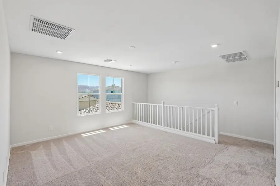 A room with a white railing and a white railing.