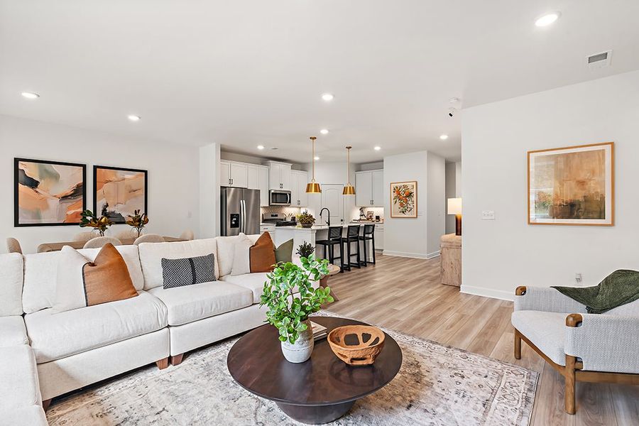 A living room with a couch and a coffee table. A living room with a couch and a coffee table.