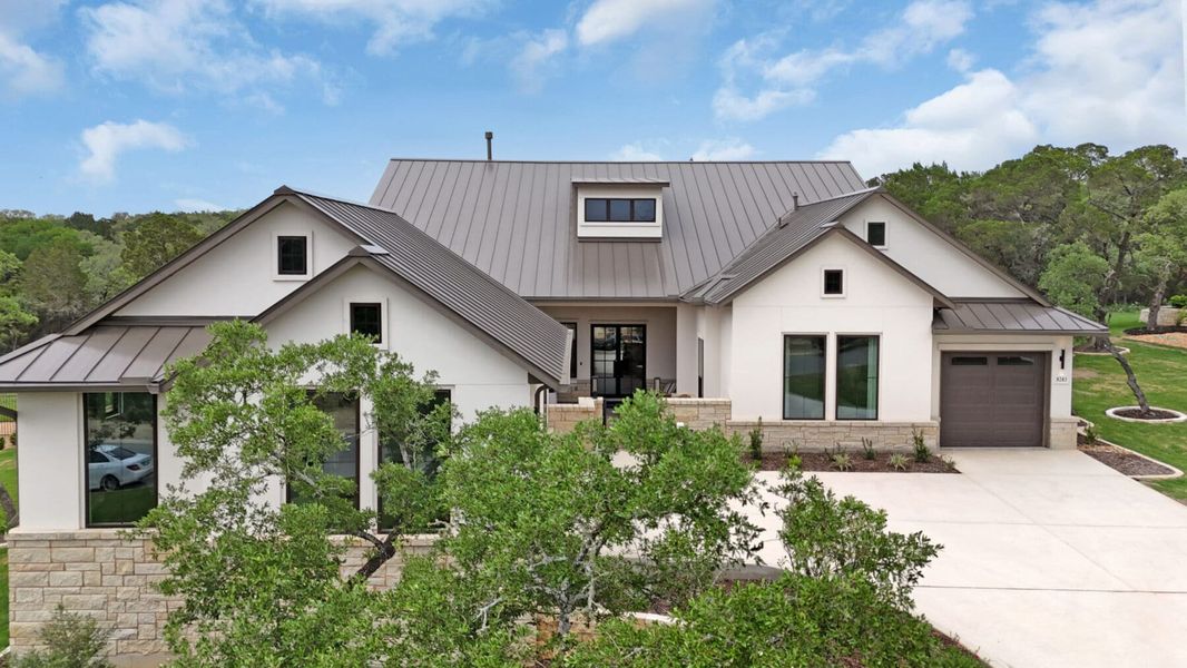 Front exterior of a new home in Enchanted Bluff, Garden Ridge, TX, highlighting curb appeal (Image 1). Front exterior of a new home in Enchanted Bluff, Garden Ridge, TX, highlighting curb appeal (Image 1).