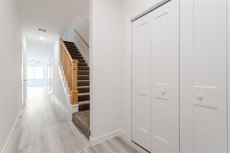 Corridor with light hardwood / wood-style floors