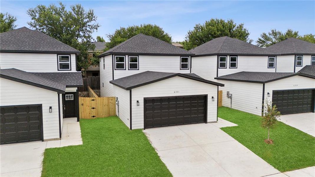 View of property with a garage and a front yard