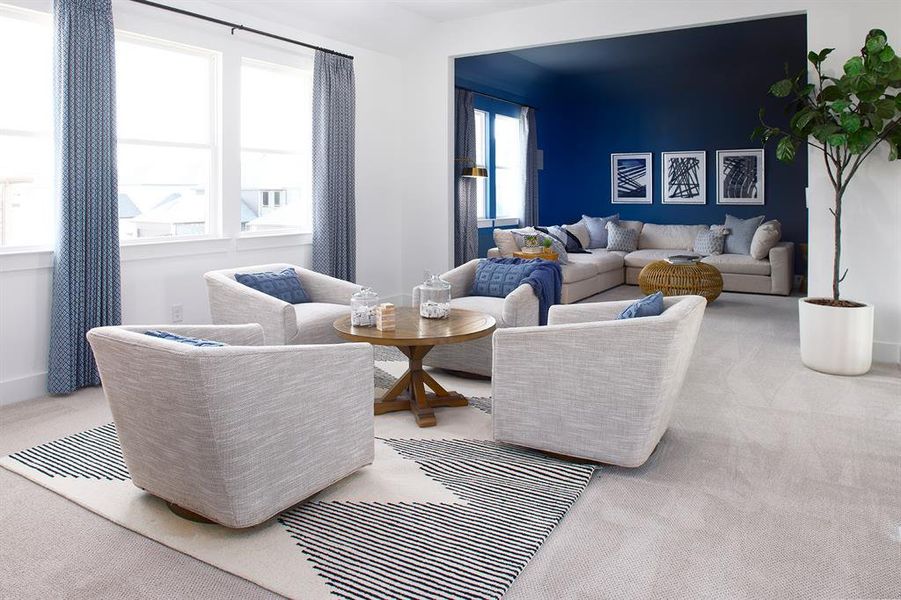 Living area with light colored carpet and baseboards