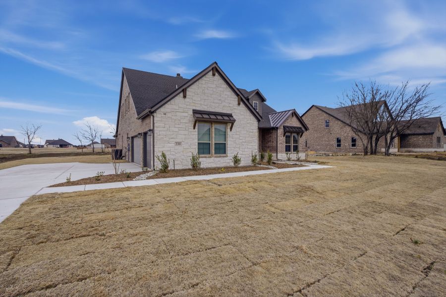 Front exterior of a new home in Fannin Ranch, Leonard, TX, highlighting curb appeal (Image 23).