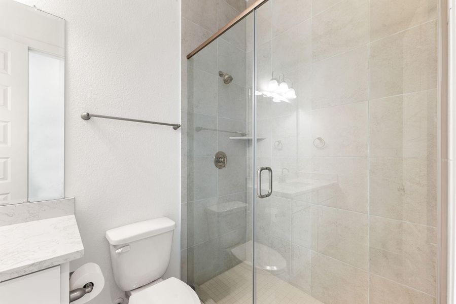 Another secondary bathroom with a walk-in shower
