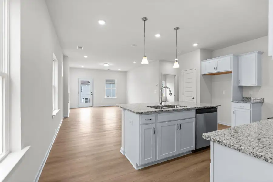 The Dove- Kitchen into Family Room. Home under construction, photo used for illustrative purposes only, colors and options will vary.