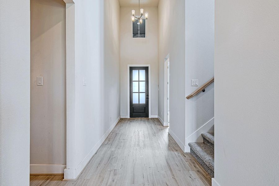 A view back toward the front entry reveals the impressive height and architectural details that define this elegant space. A view back toward the front entry reveals the impressive height and architectural details that define this elegant space.