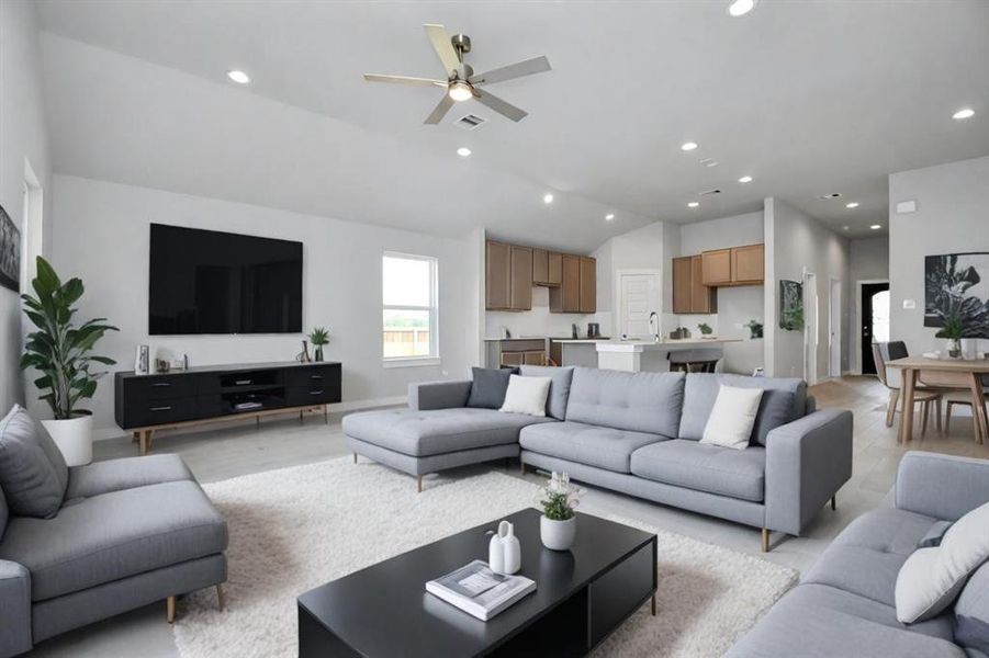 Family room flooded with natural light through the expansive windows.  The premium tile flooring adds a touch of luxury to the space, creating the perfect setting for relaxing moments and cherished gatherings with loved ones.  Sample photo of completed home with similar floor plan. Actual colors and selections may vary.