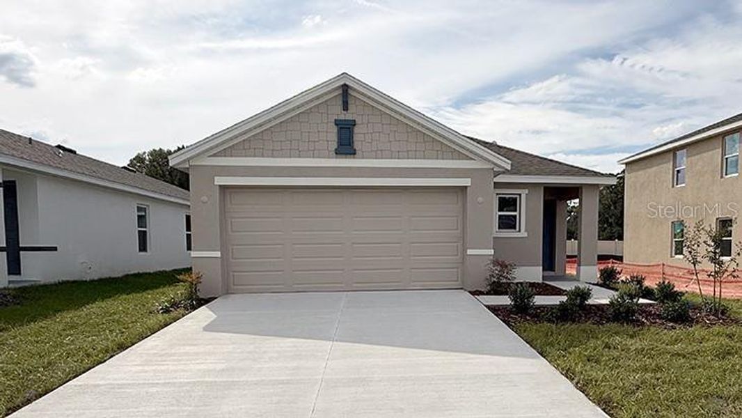 Front exterior of a new home in Emerson Pointe, Ocala, FL, highlighting curb appeal (Image 1). Front exterior of a new home in Emerson Pointe, Ocala, FL, highlighting curb appeal (Image 1).